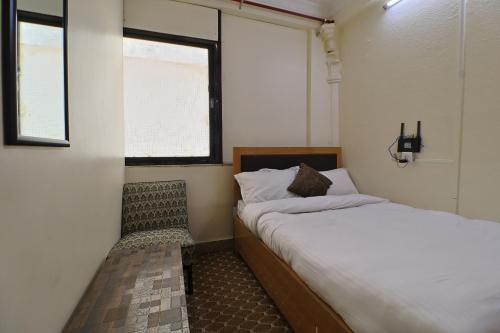 a small bedroom with a bed and a window at OYO 828 Hotel White Dreams Palace in Kathmandu