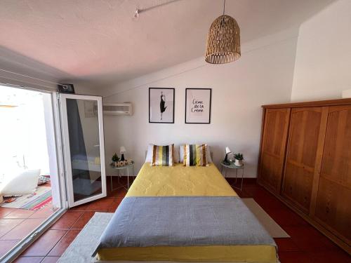 a bedroom with a large bed in a room at Casa Das Estrelas Vista Mertola Praia Fluvial in Mértola