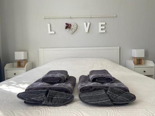 a bedroom with a bed with two towels on it at Sweet Home - 55m2 appartment, garden, swimming pool, parking in Toulouse