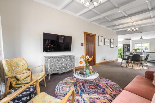 a living room with a couch and a table at Point Chevalier Life in Auckland