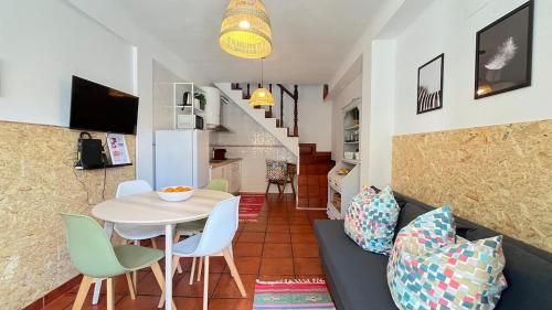 a living room and dining room with a table and chairs at Casa Das Estrelas Vista Mertola Praia Fluvial in Mértola
