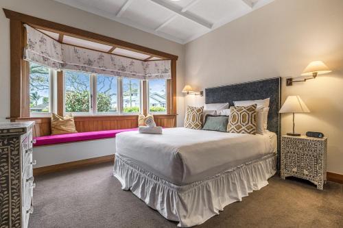 a bedroom with a large bed and a window at Point Chevalier Life in Auckland