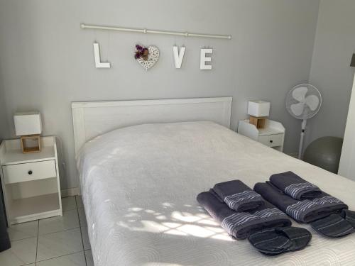 a bedroom with a bed with two purple towels on it at Sweet Home - 55m2 appartment, garden, swimming pool, parking in Toulouse