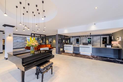 a living room with a piano and a bar at Clybaun Hotel in Galway