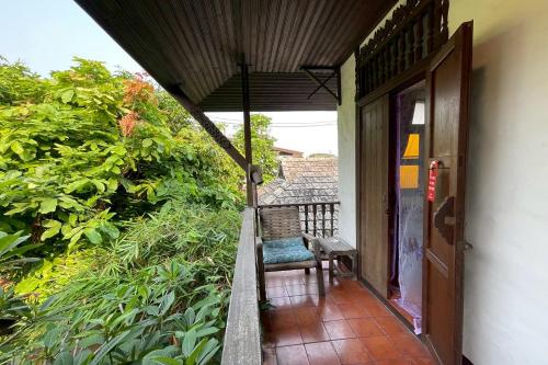 an open door to a porch with a chair on it at The Royal Shilton Resort in Chiang Mai