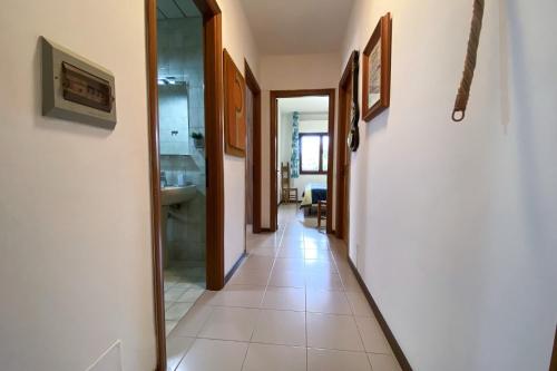 a hallway with a mirror and a tile floor at Casa Magnanina Sarda in Oristano