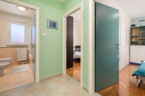 a bathroom with a large glass door in a room at Apartman Kvarner in Rijeka