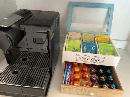 a box of wine and candy next to a coffee maker at Sweet Home - 55m2 appartment, garden, swimming pool, parking in Toulouse