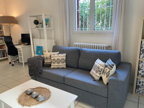 a living room with a blue couch and a table at Sweet Home - 55m2 appartment, garden, swimming pool, parking in Toulouse