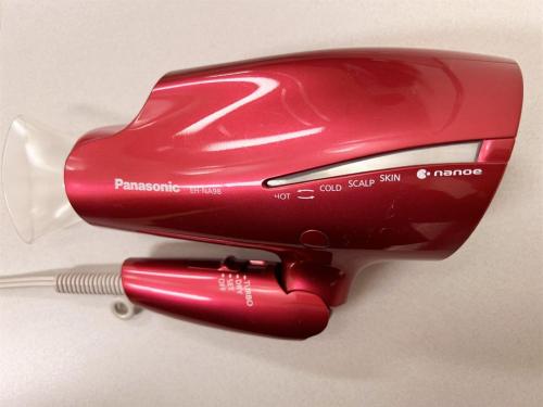 a red hair dryer sitting on top of a counter at Hotel Hokke Club Sapporo in Sapporo
