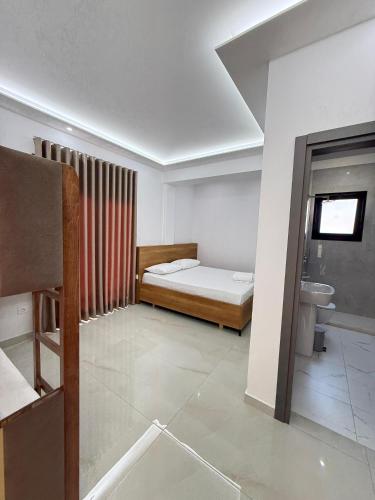 a bedroom with a bed and a sink in a room at Villa Papa-Berat in Berat