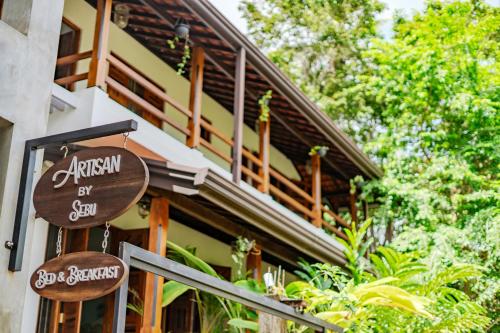 a sign for a restaurant in front of a building at Artisan By Sebu in Galle