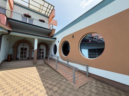 a building with a round window and a balcony at Penzión Siroň in Detva