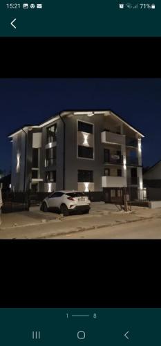 a car parked in front of a building at night at Vibe Apartment in Sighetu Marmaţiei