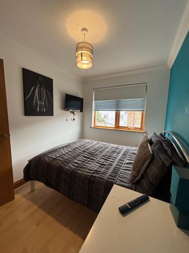a bedroom with a bed and a window and a desk at Apt 5a Central by river 1 Bed Apartment in Norwich