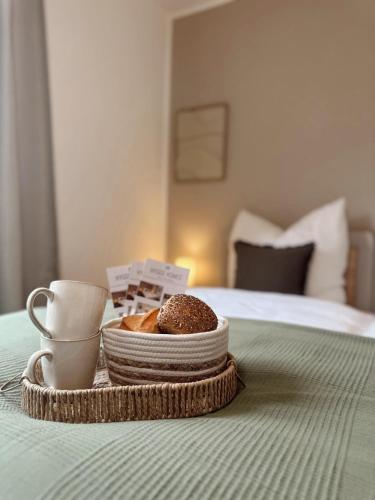 a tray with a plate of donuts on a bed at Hygge Homes - Design Apartment Nähe Schloss in Celle