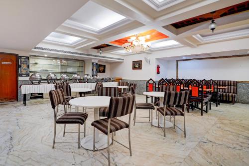 a banquet hall with tables and chairs in a room at Super Townhouse Civil Aviation HAL Road in Bengaluru