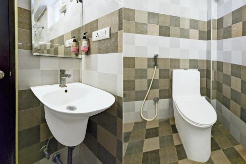 a bathroom with a sink and a toilet at Townhouse HiTech city Hyderabad in Hyderabad