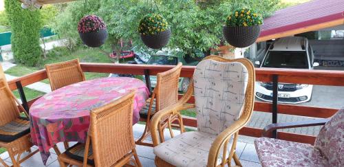 a table and chairs on a porch with a table at Casa Misha in Petreşti