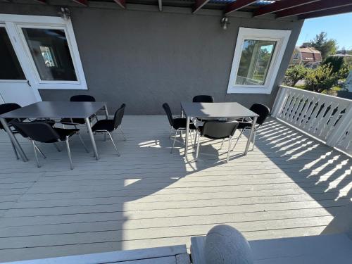 a patio with two tables and chairs on a deck at Villa ICRE 23A in Överum