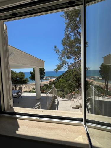a view of the ocean from a house window at Vento Verde Apartments in Sperlonga