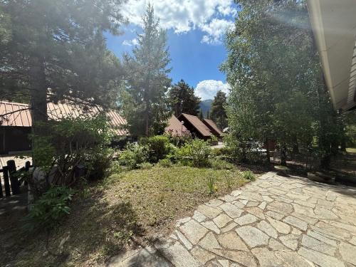 a garden with a stone walkway in front of a house at Les Chalets de Barcelonnette in Barcelonnette