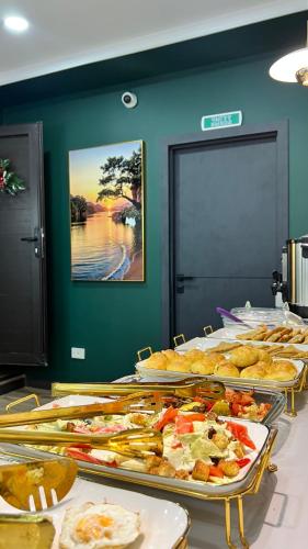a buffet with many plates of food on a table at Suncor Hotel in Karakol