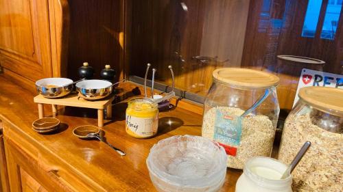 a kitchen counter with bowls of food and oats at Organic BnB Froschkoenig Gersau in Gersau