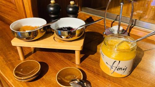 a table with two bowls and a jar of orange juice at Organic BnB Froschkoenig Gersau in Gersau