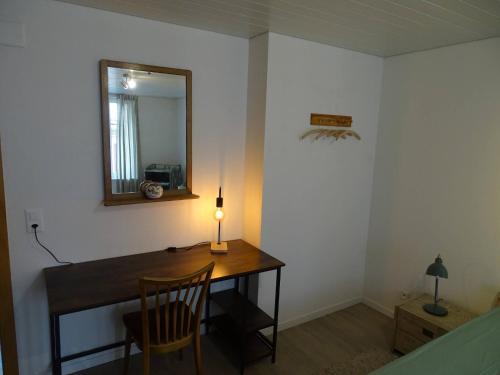 a room with a desk with a mirror and a lamp at Organic BnB Froschkoenig Gersau in Gersau