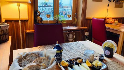 a table with a tray of bread on a table at Organic BnB Froschkoenig Chaiserstock in Gersau