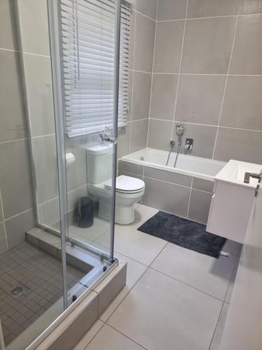 a bathroom with a toilet and a sink and a shower at paradise in Ballito in Ballito