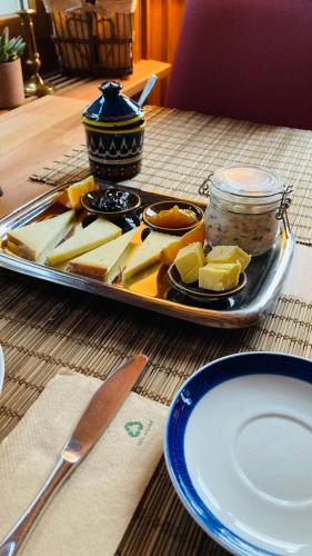 a tray of food on a table with a plate of cheese at Organic BnB Froschknig Dorfplatz in Gersau
