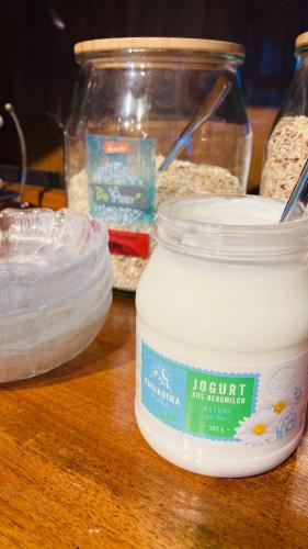 a table with a jar of soy sauce and other ingredients at Organic BnB Froschknig Dorfplatz in Gersau