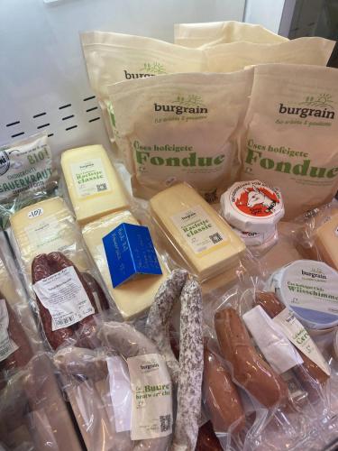 a table topped with different types of cheese and meats at Organic BnB Froschknig Dorfplatz in Gersau