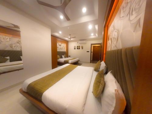 a bedroom with a large bed in a room at Hotel Narmada Palace in Ujjain