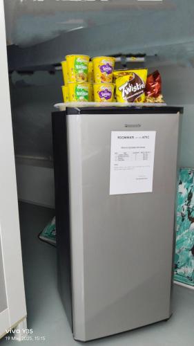 a refrigerator with some food on top of it at ROOMMATE On The ATTIC in Kuah