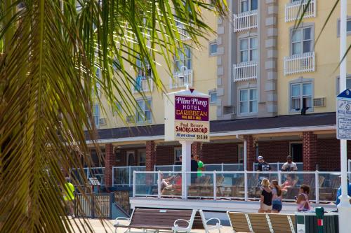 a hotel deck with a sign for a swim up bar at Plim Plaza Hotel in Ocean City