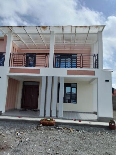 a large white house with a balcony at Blessed Home, Nakuru in Nakuru