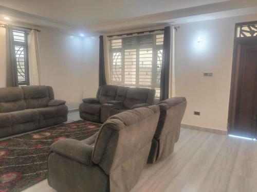 a living room with a couch and two chairs at Blessed Home, Nakuru in Nakuru