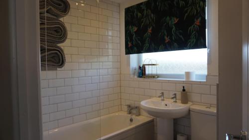 a bathroom with a sink and a bath tub at Modern 1 bedroom house in Lincolnshire