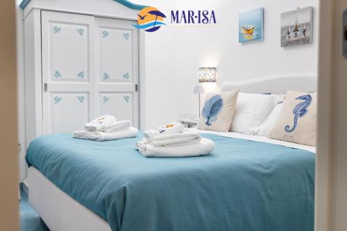 a bedroom with a bed with towels on it at MAR-ISA Amalfi Coast in Vietri sul Mare