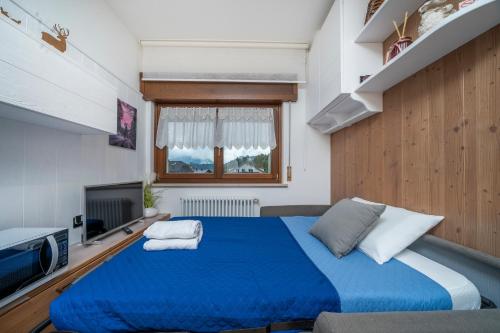 Postel nebo postele na pokoji v ubytování GuestHost - Comfy Apartments in Tarvisio Central