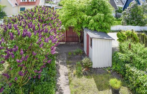 a garden with purple flowers and a fence at 1 Bedroom Beautiful Home In Limhamn in Limhamn