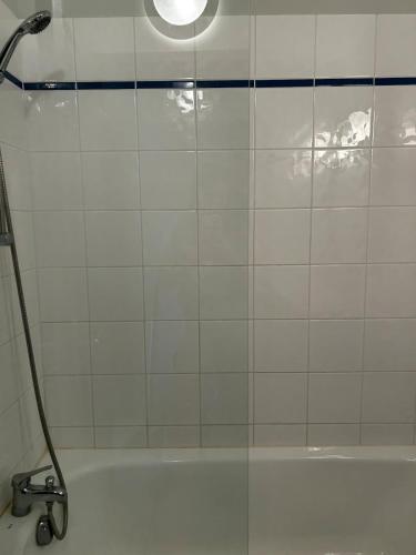 a shower with a glass door in a bathroom at L'Erable T2 climatisé in Trébas