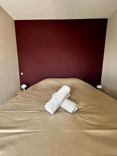 a bed with two rolls of toilet paper on it at L'Erable T2 climatisé in Trébas