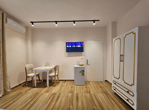 a kitchen and dining room with a table and a refrigerator at Star Room's in Durrës