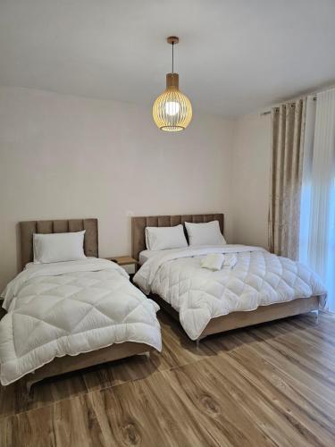 two beds sitting next to each other in a bedroom at Star Room's in Durrës