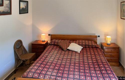 a bedroom with a bed with two night stands and two lamps at Beautiful Home In Montalto Di Castro in Montalto di Castro