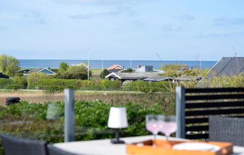 a table with wine glasses on top of a balcony at Amazing Home In Karrebæksminde in Karrebæksminde